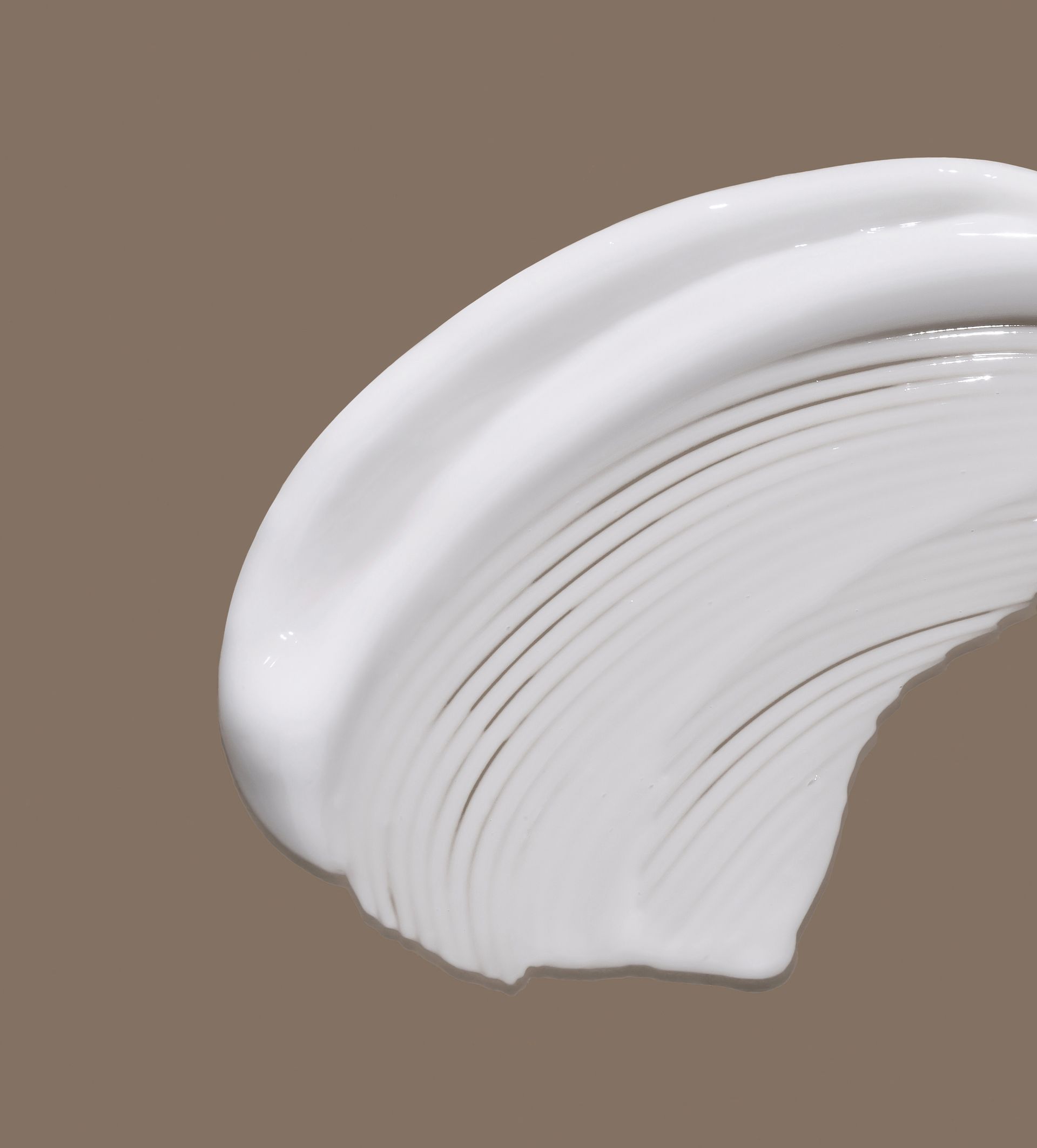 A close up of a white cloth with waves on a white background.