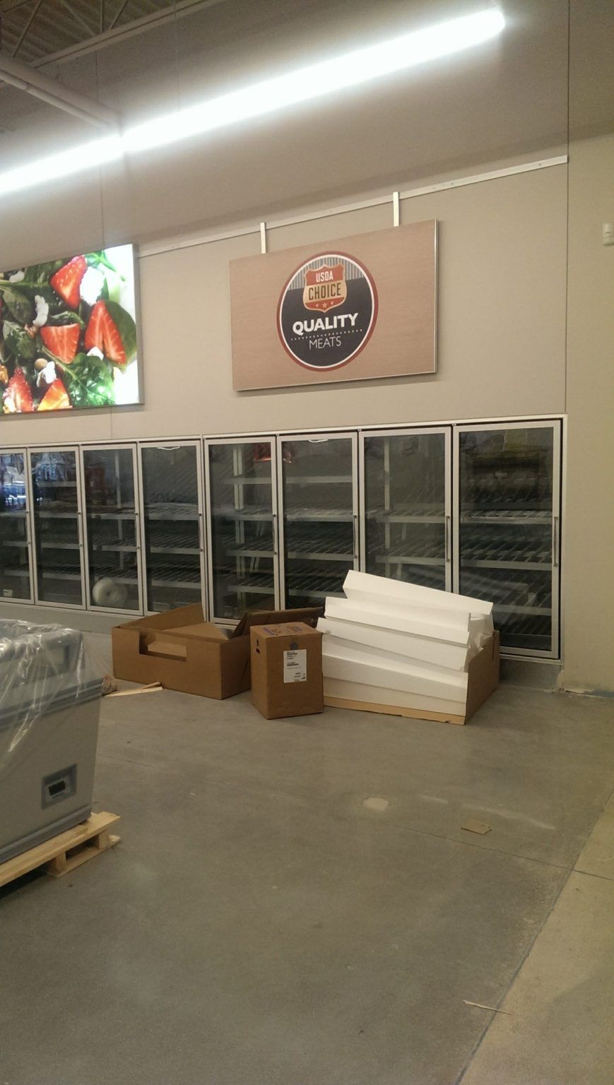 A warehouse with a lot of boxes and a sign on the wall.