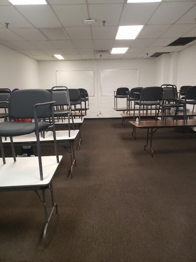 A room with a lot of chairs and tables