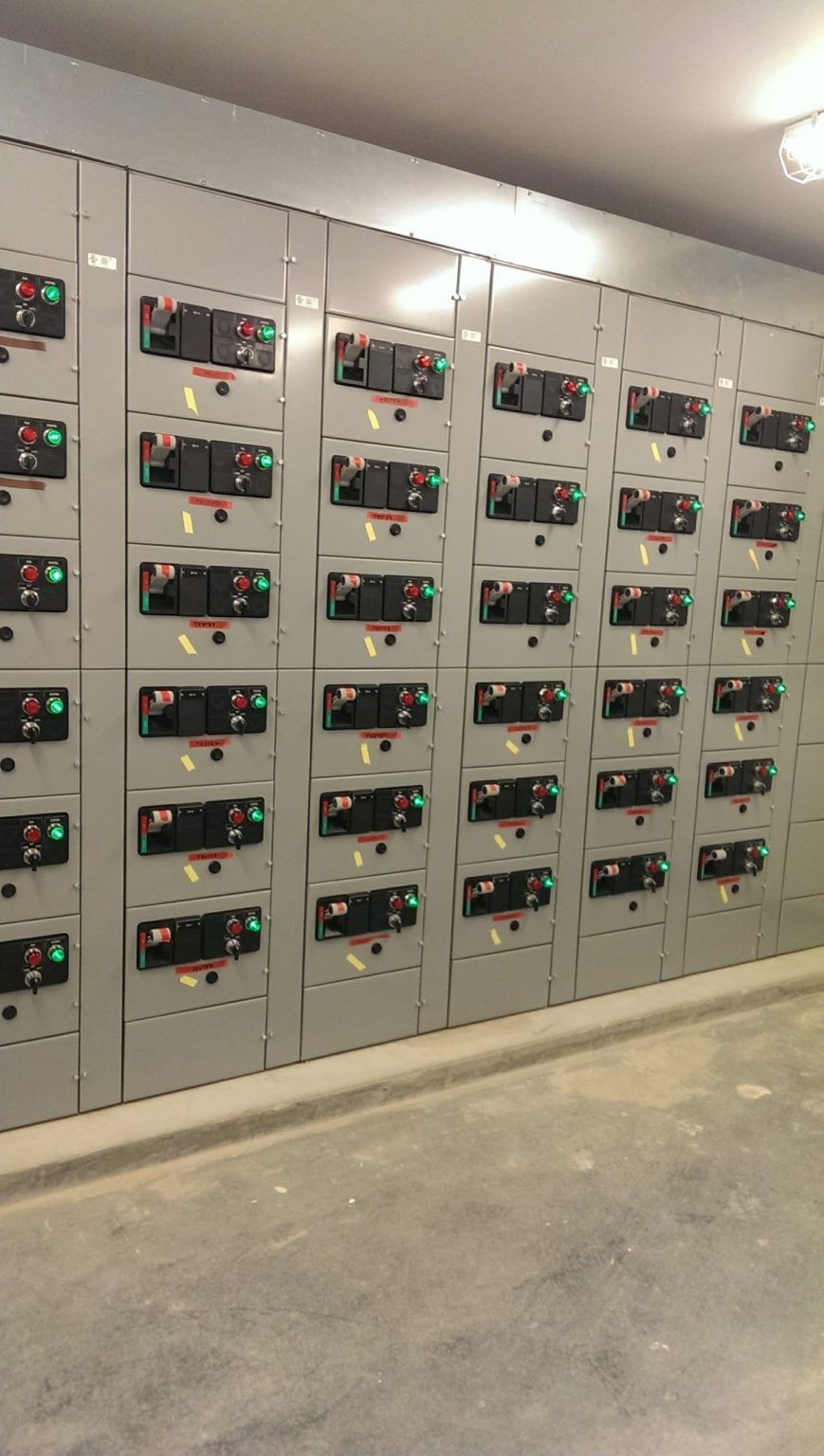 There are a lot of electrical boxes on the wall.