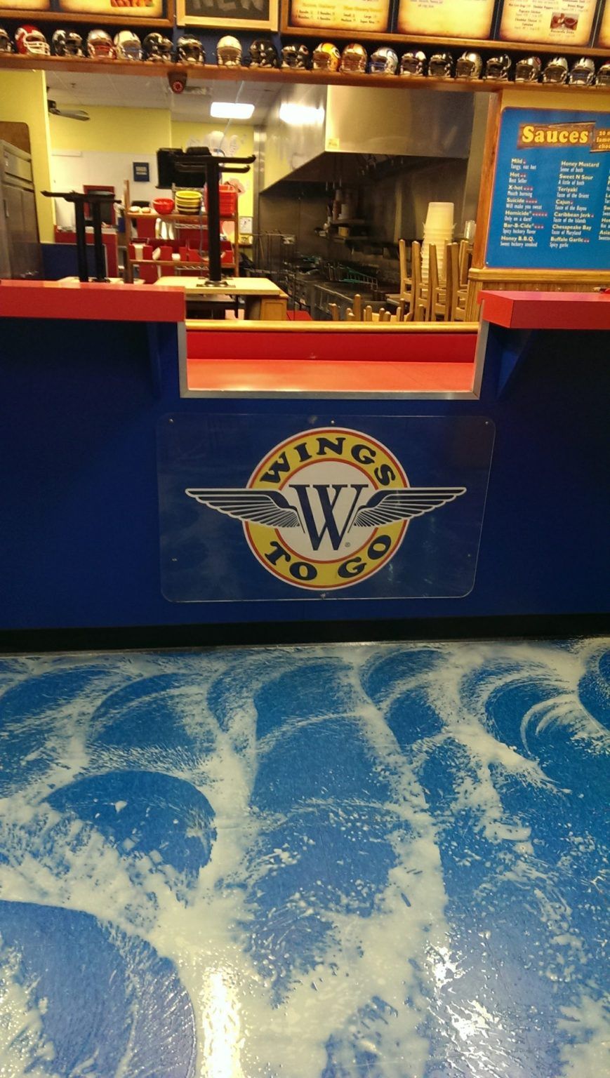 A restaurant with a sign that says wings to go