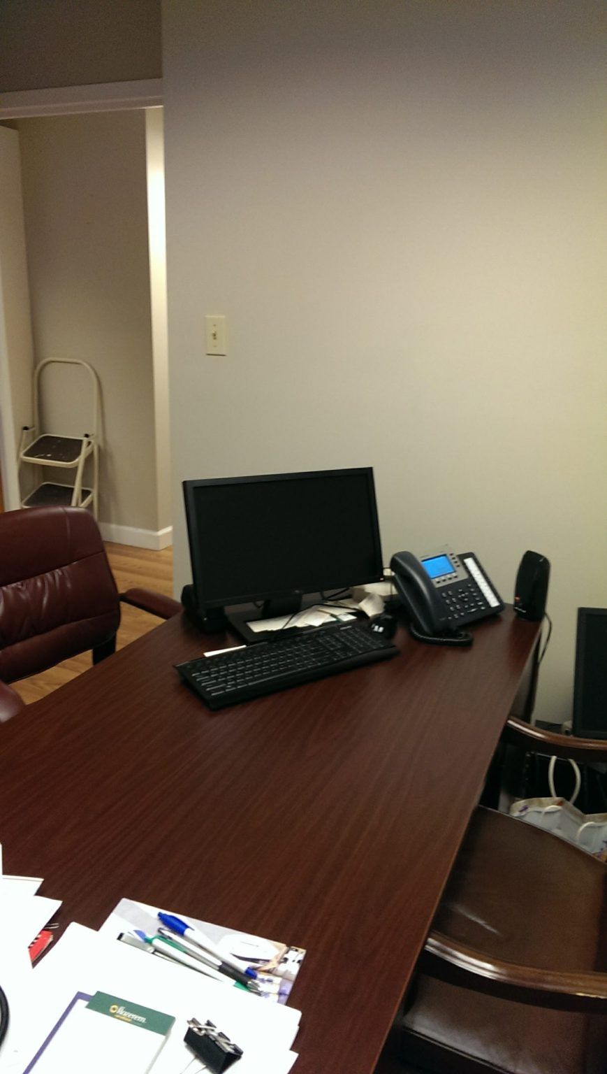A desk with a computer and a phone on it