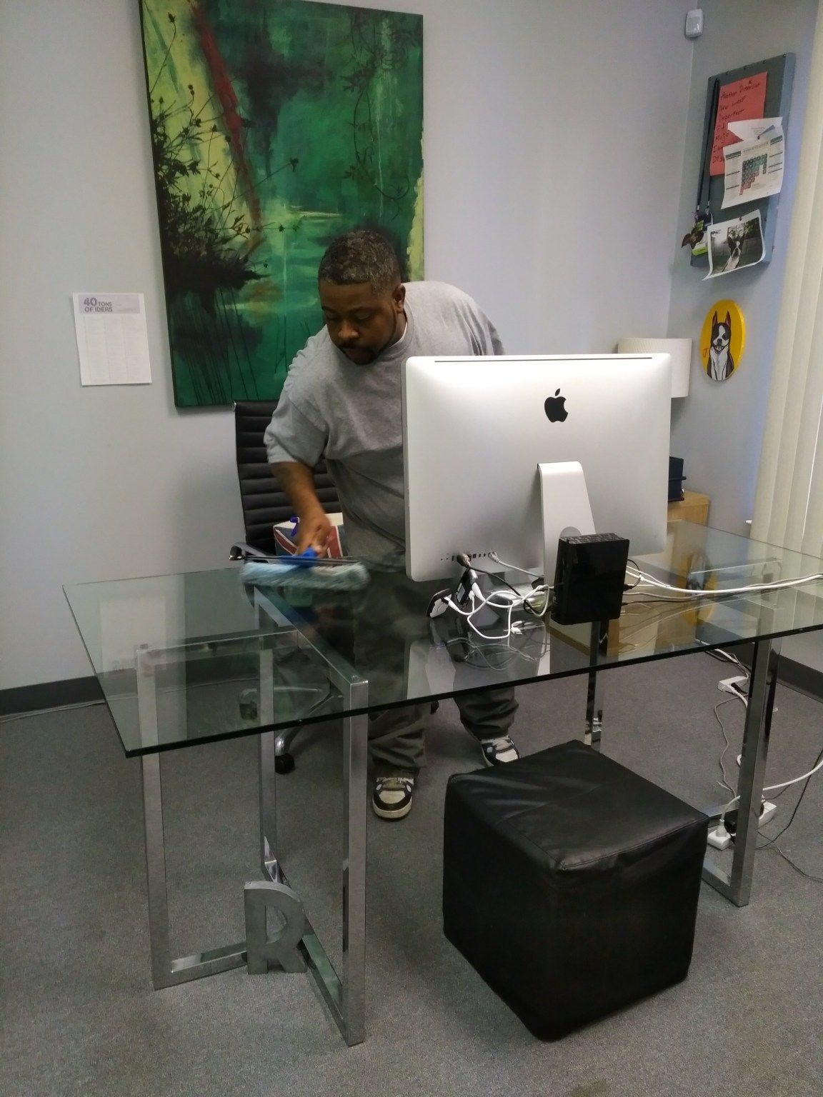 A man sitting at a desk with an apple computer