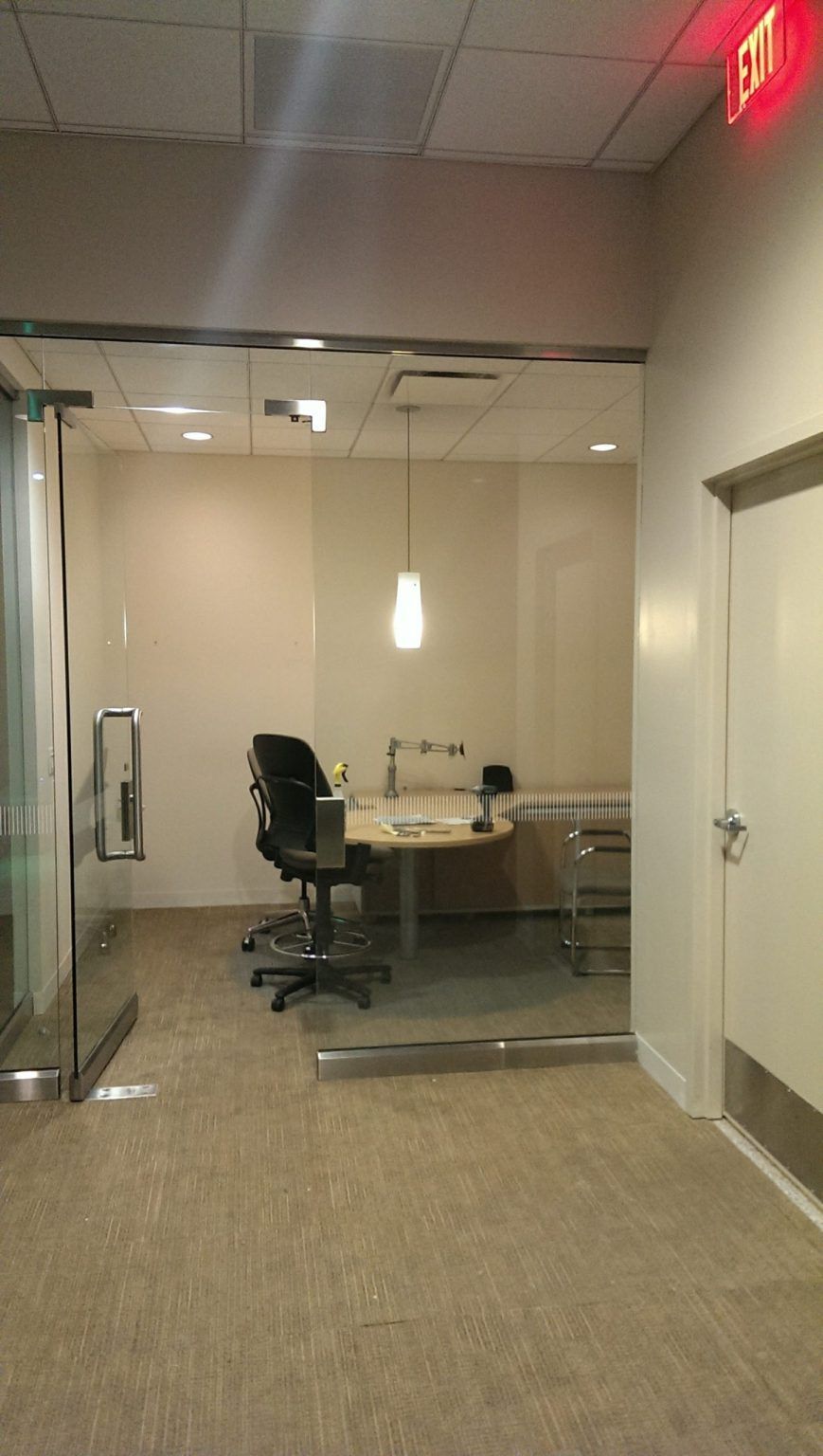 There is a red exit sign in the corner of the room.