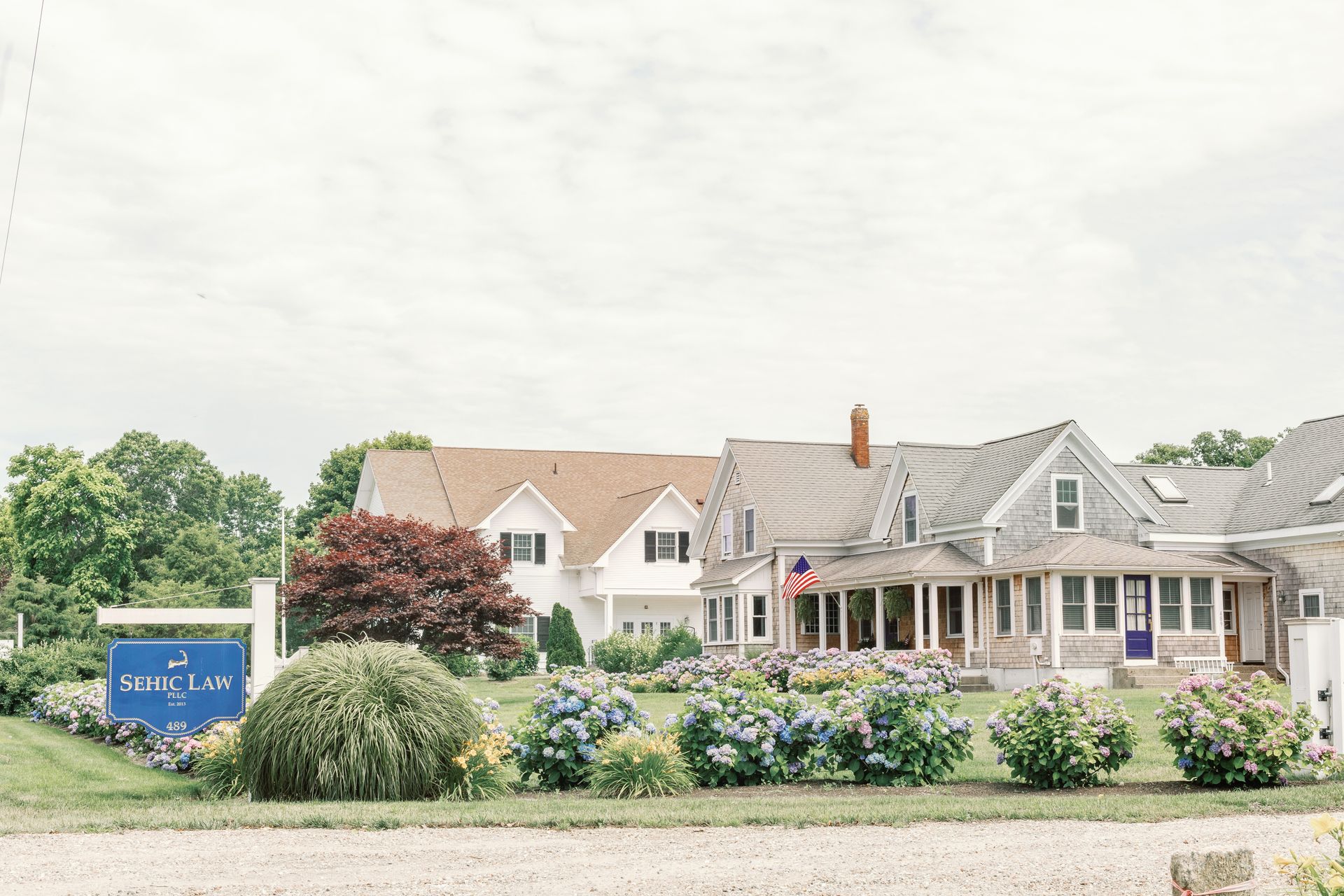 A nurse is holding the hands of an elderly woman.