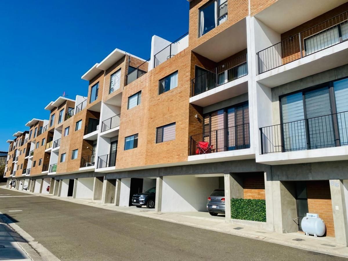 Looking up at a tall building with a blue sky in the background.