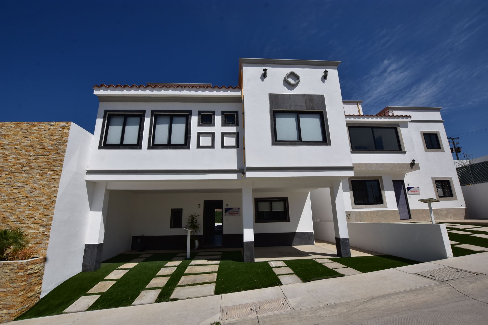 A large white house with a black garage door