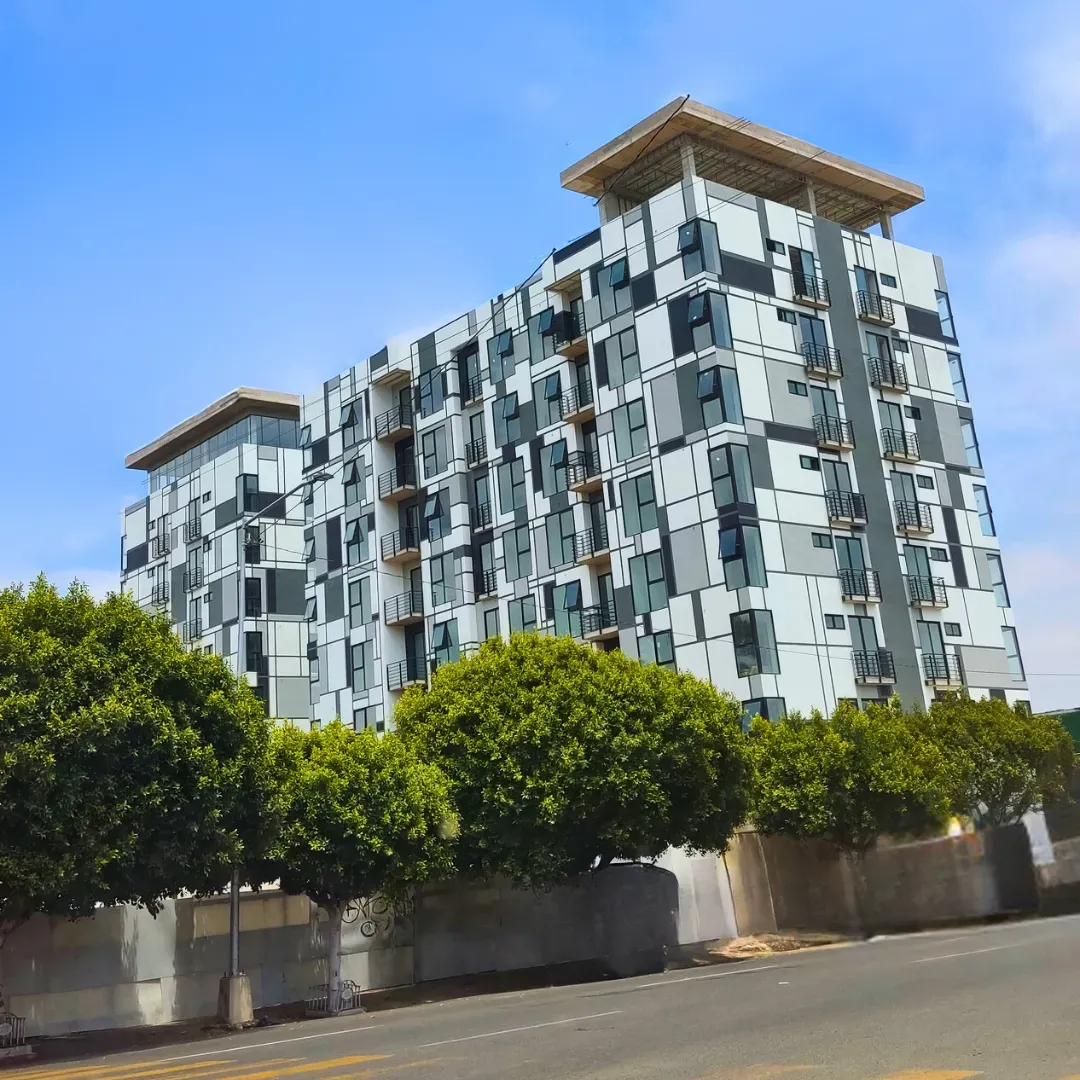 A large white house with a wooden staircase in front of it.
