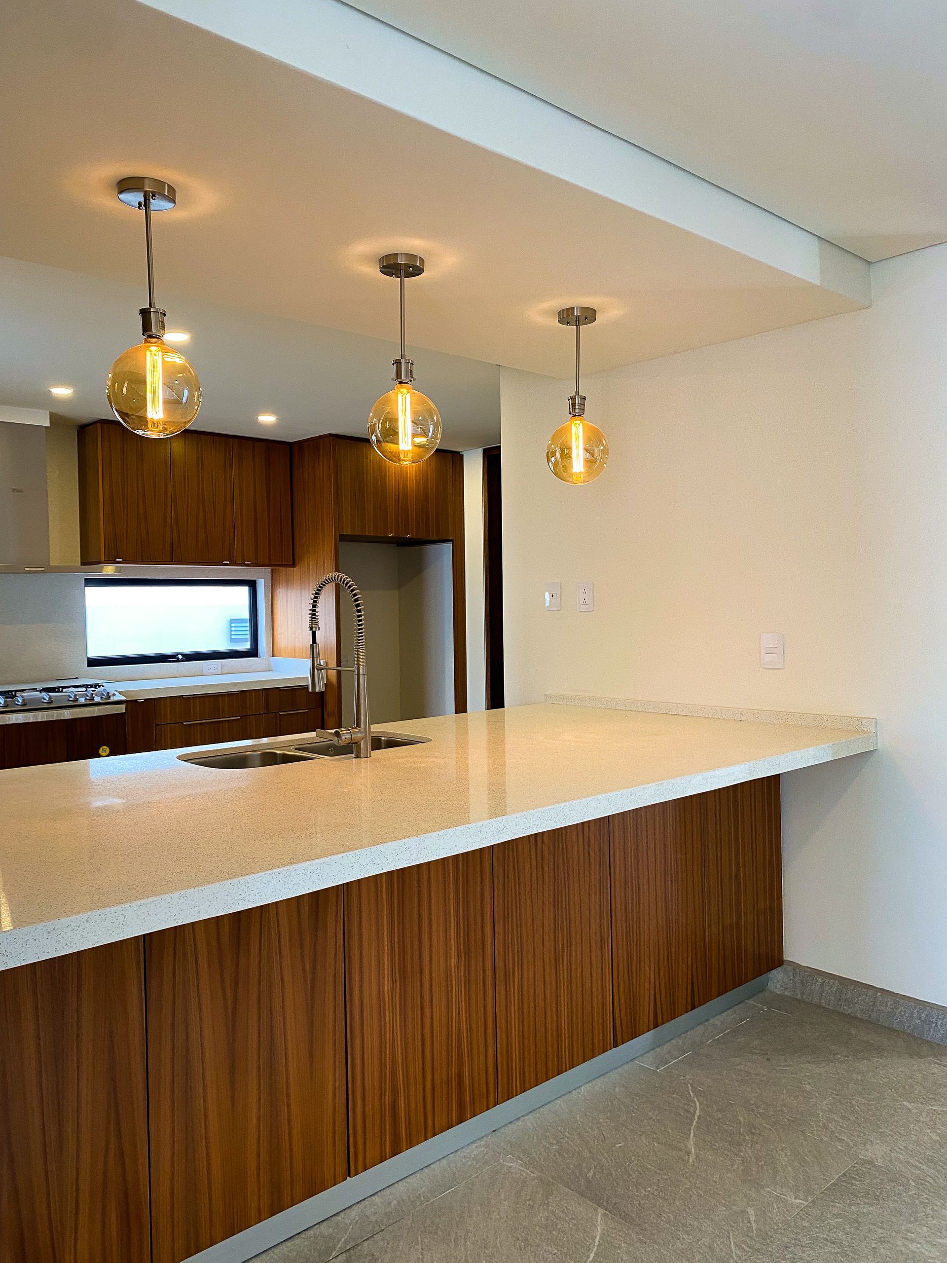 A kitchen with wooden cabinets and a granite counter top