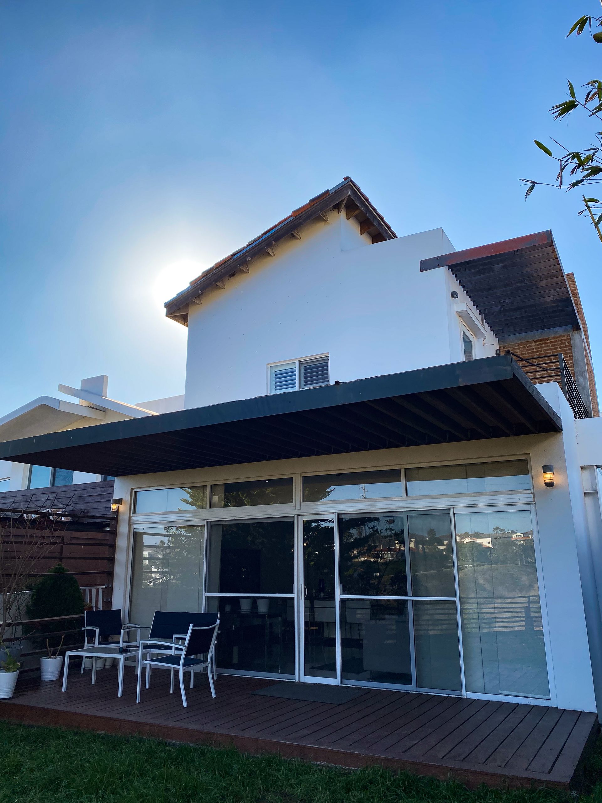 A white house with a patio and sliding glass doors