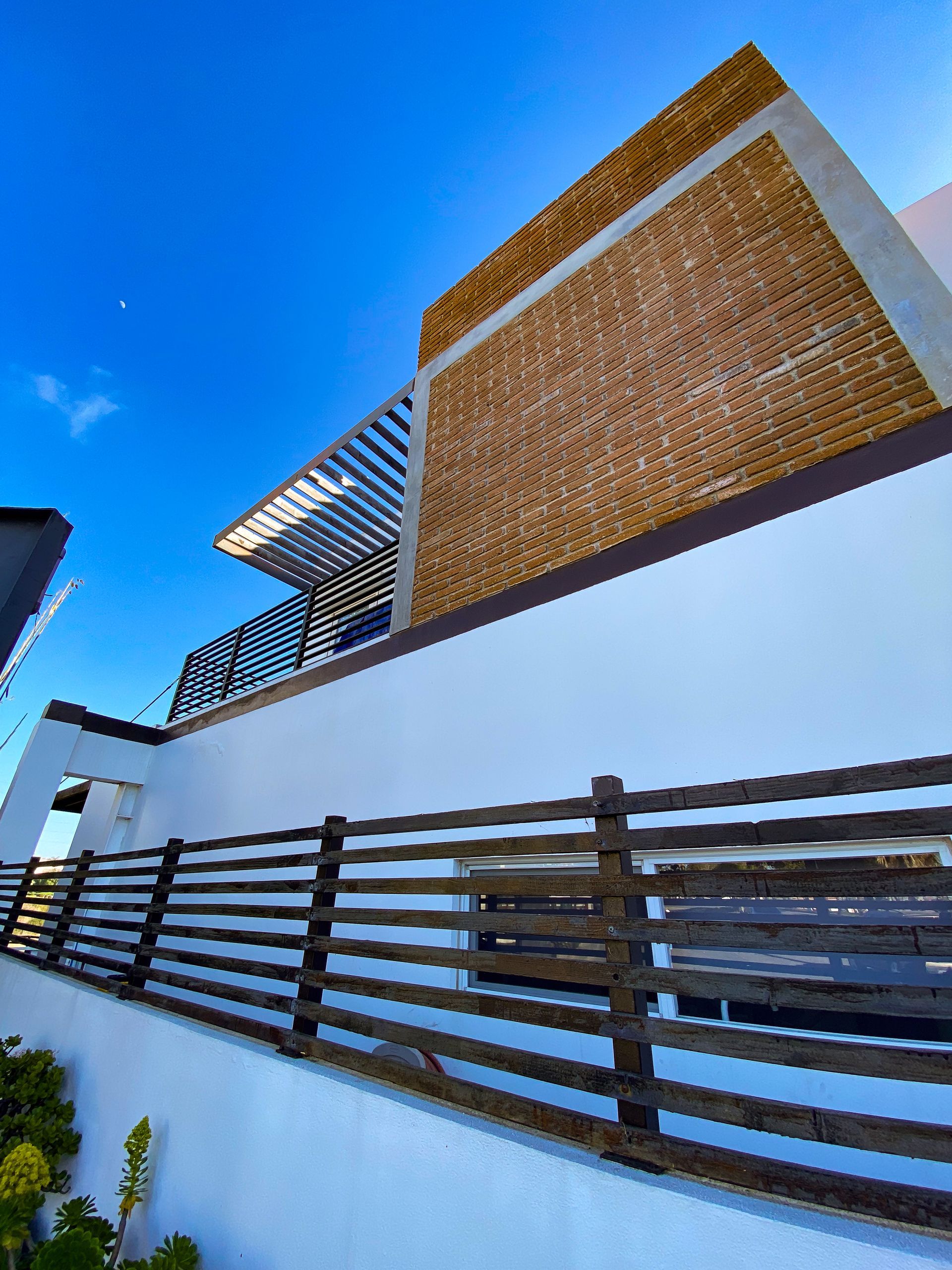 A white building with a wooden fence around it