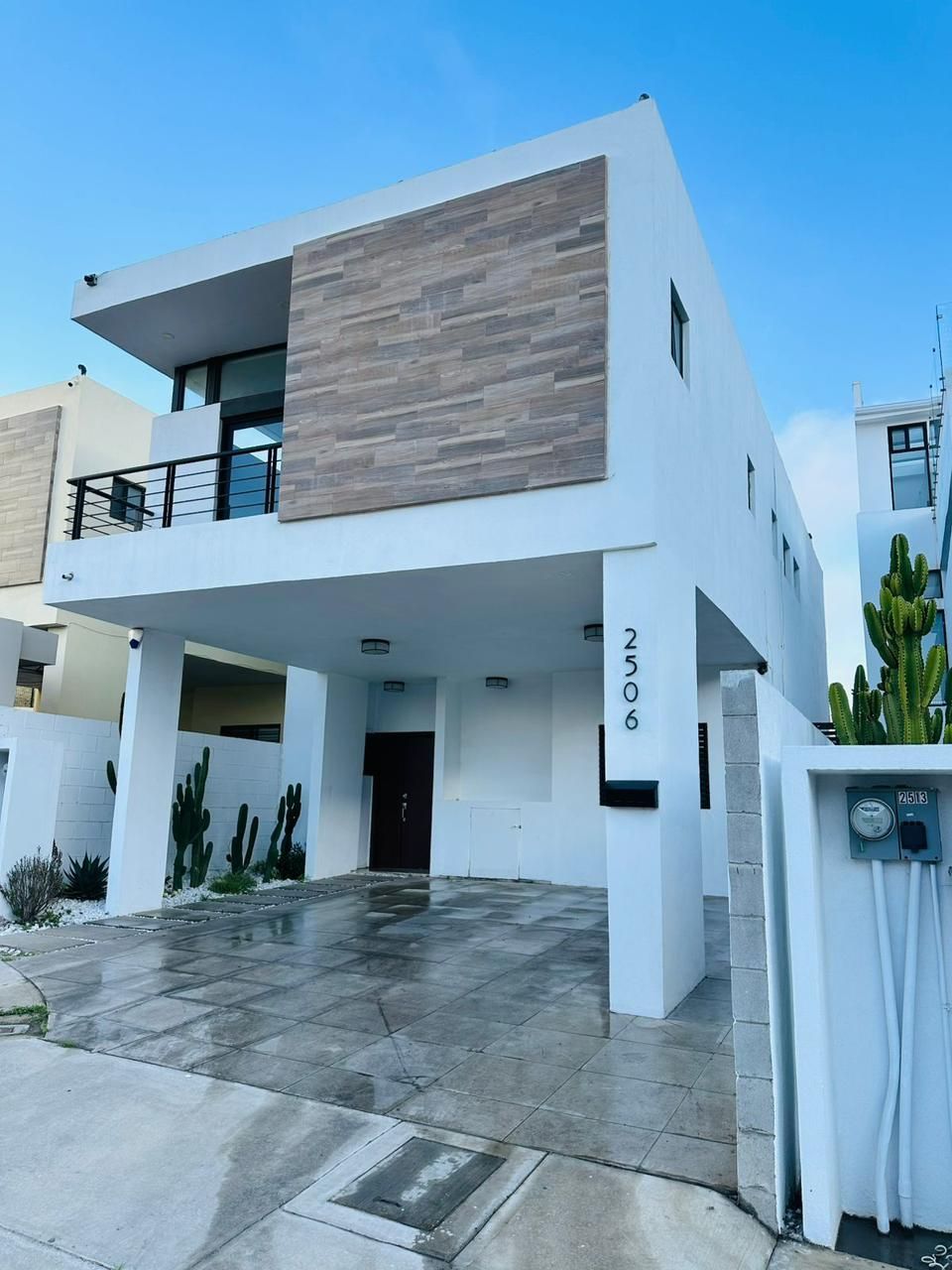 A large white house with a black garage door