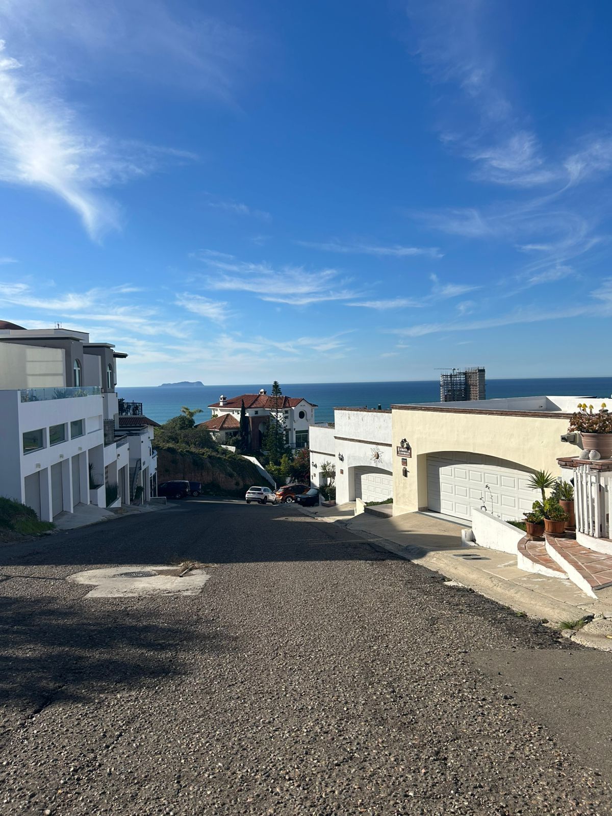 A white house with a balcony and a wooden door