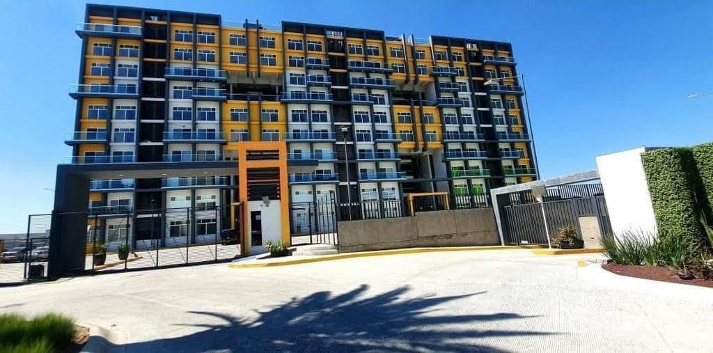 A conference room with a table and chairs and a painting on the wall.
