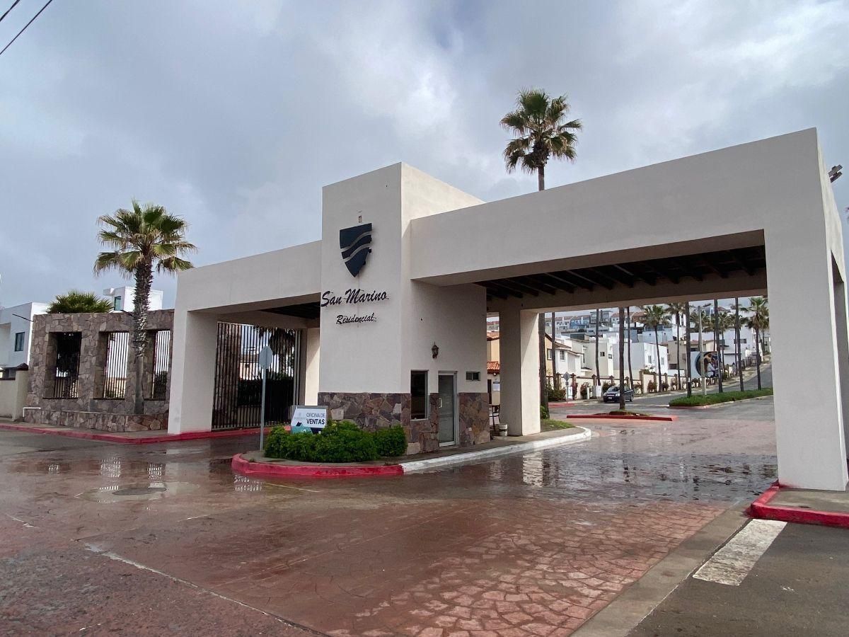 An aerial view of a building on a cliff overlooking the ocean.