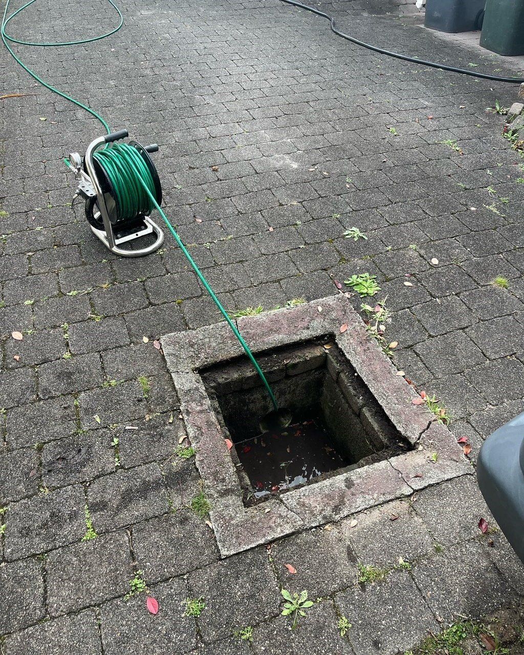 Plumber Unclogging Washbasin's Siphon In A Bathroom — Distinct Plumbing Services In Barrack Heights NSW
