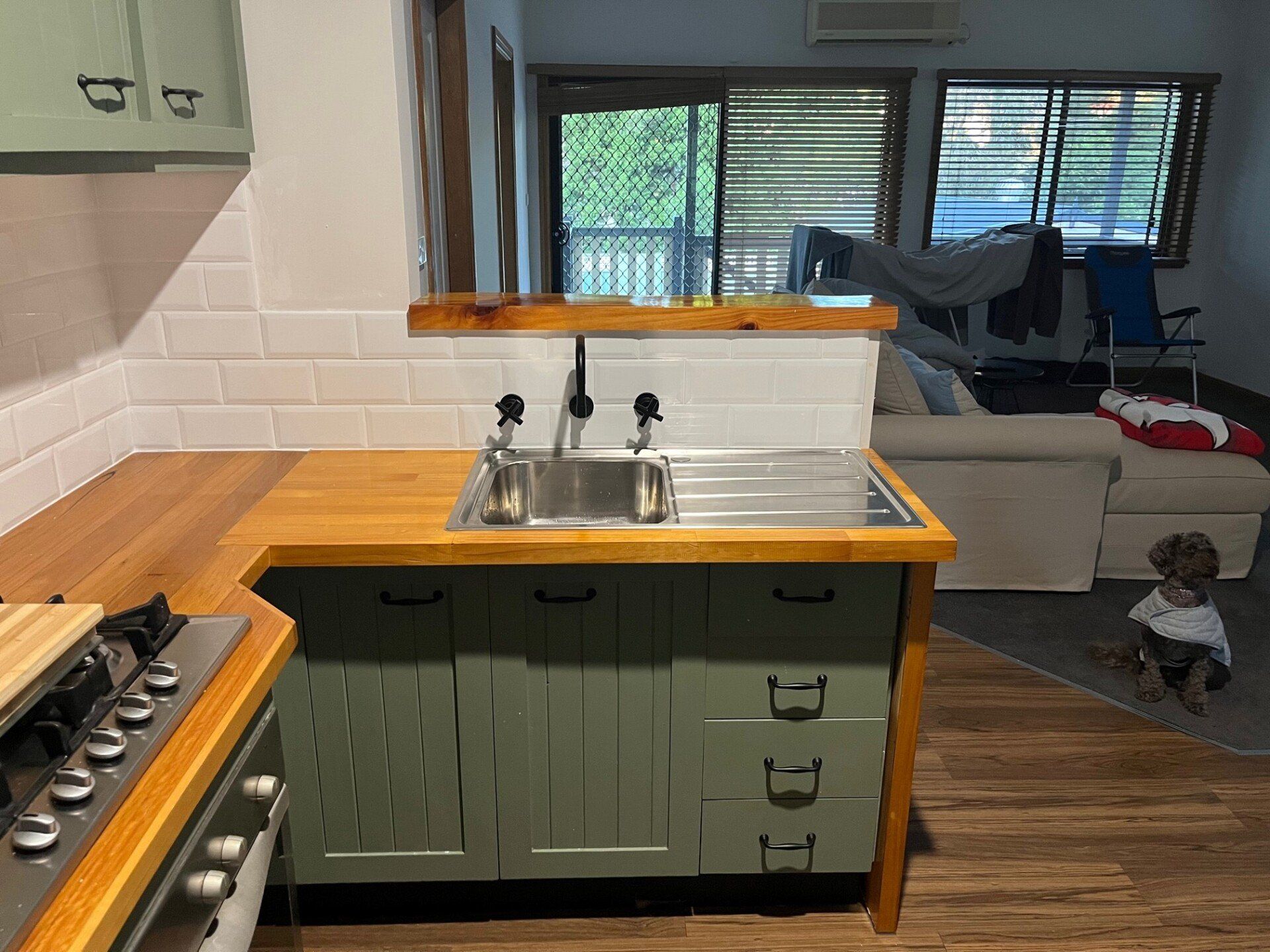 Plumber Repairing Tap In A Kitchen — Distinct Plumbing Services In Barrack Heights NSW