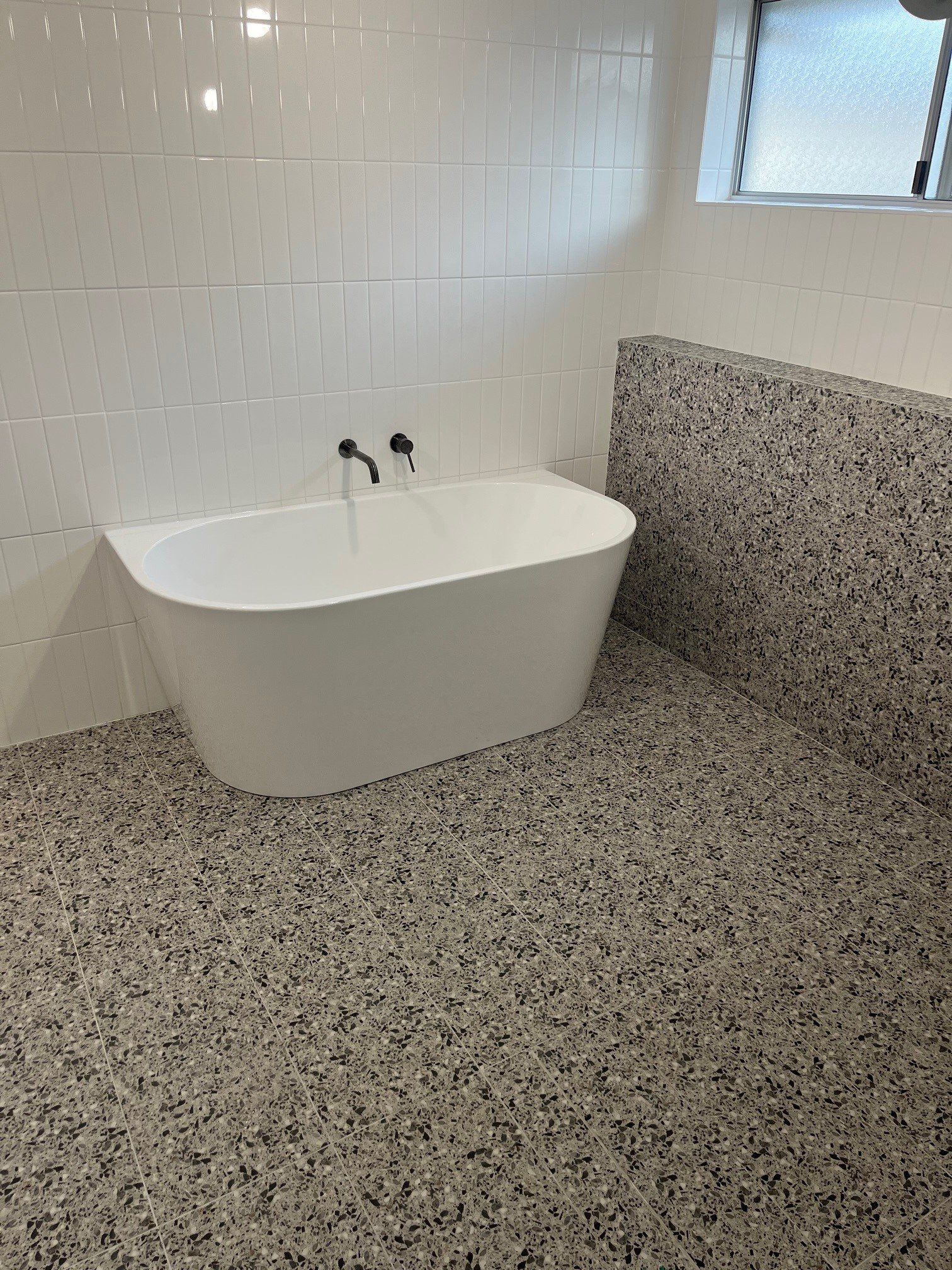 Smiling Technician Repairing An Hot Water Heater — Distinct Plumbing Services In Barrack Heights NSW