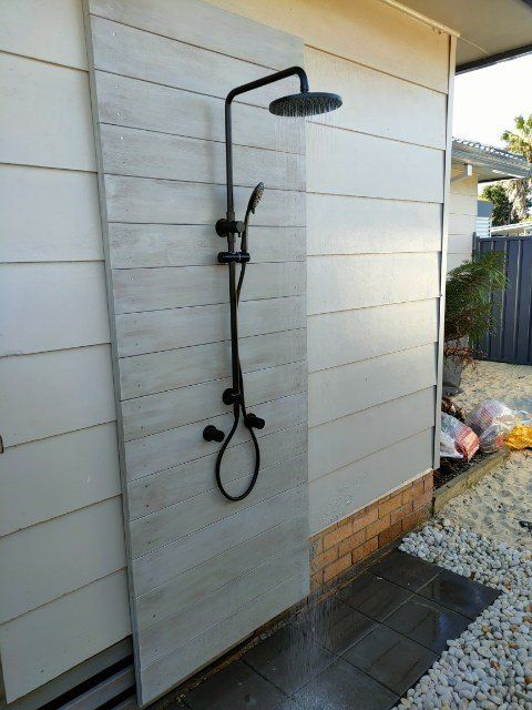 Plumber With Wrench Fixing The Pipe Under The Sink — Distinct Plumbing Services In Barrack Heights NSW