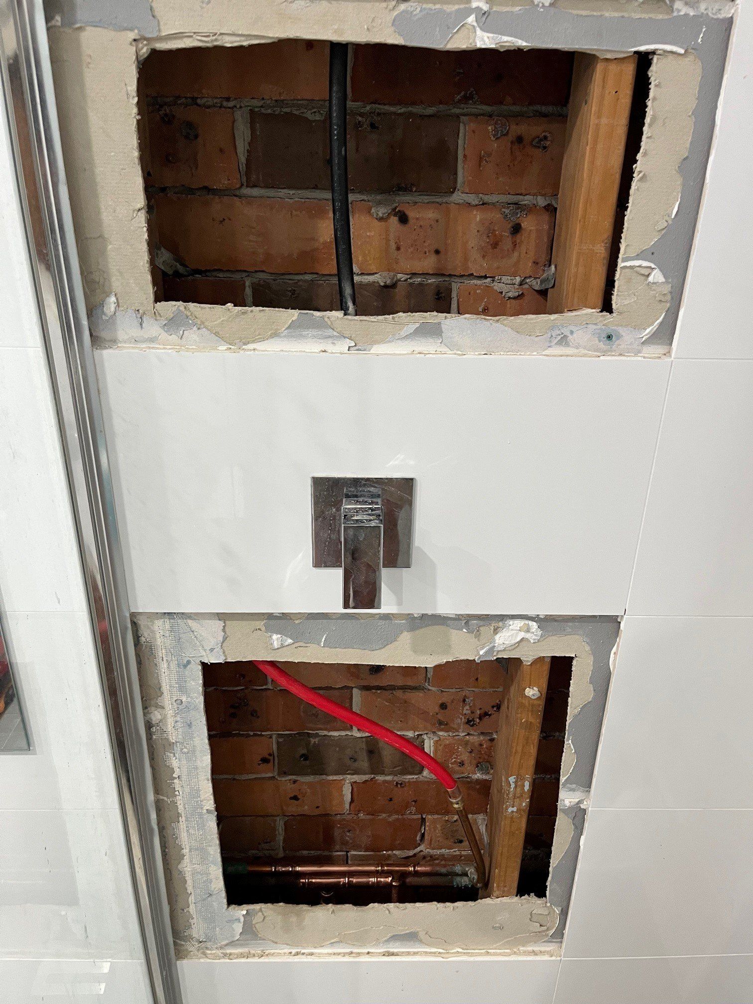 Portrait Of Male Plumber Fixing A Sink In Bathroom — Distinct Plumbing Services In Barrack Heights NSW
