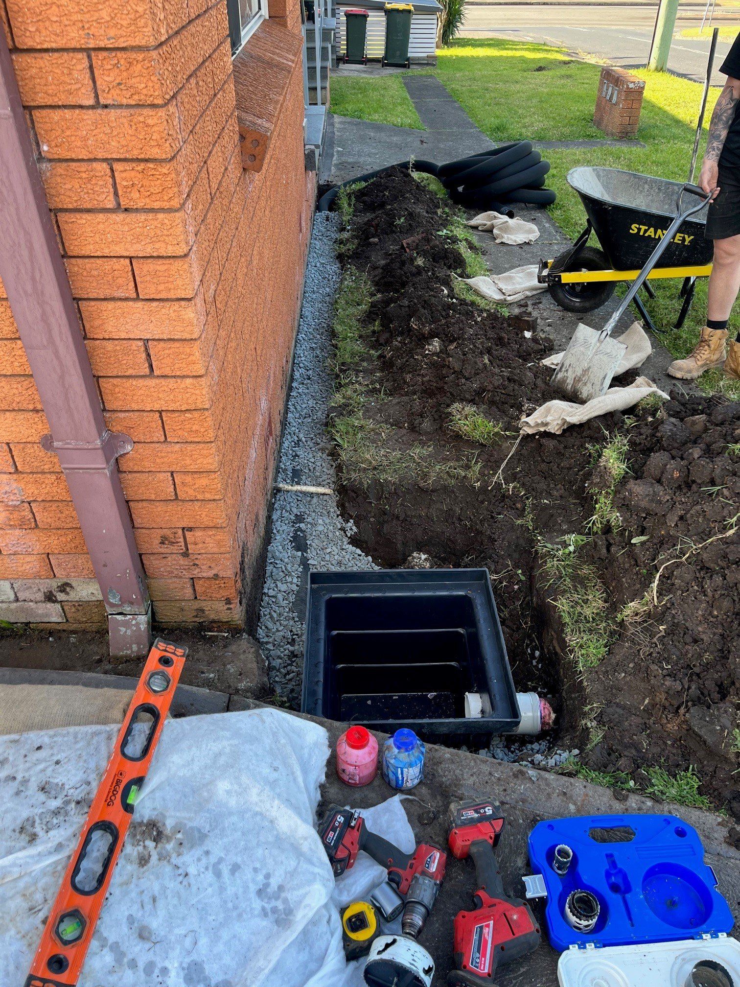 Laying Drainage Pipes Into The Ground — Distinct Plumbing Services In Dapto