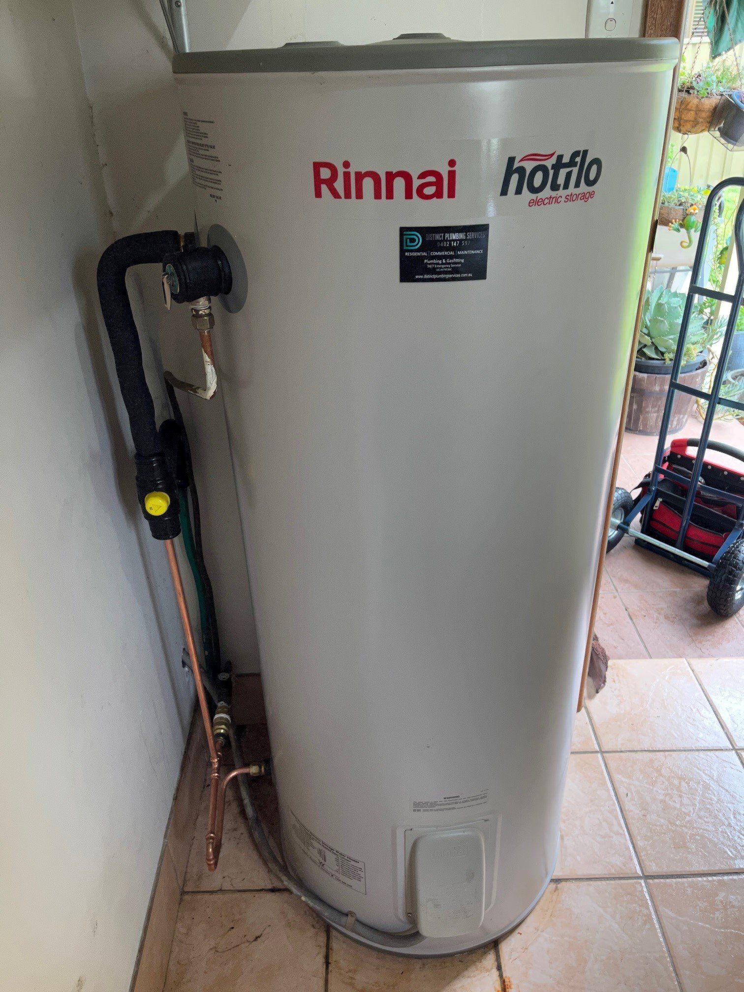 Plumber Attaches To Pipe Gas Boiler Using Adjustable Wrench — Distinct Plumbing Services In Barrack Heights NSW