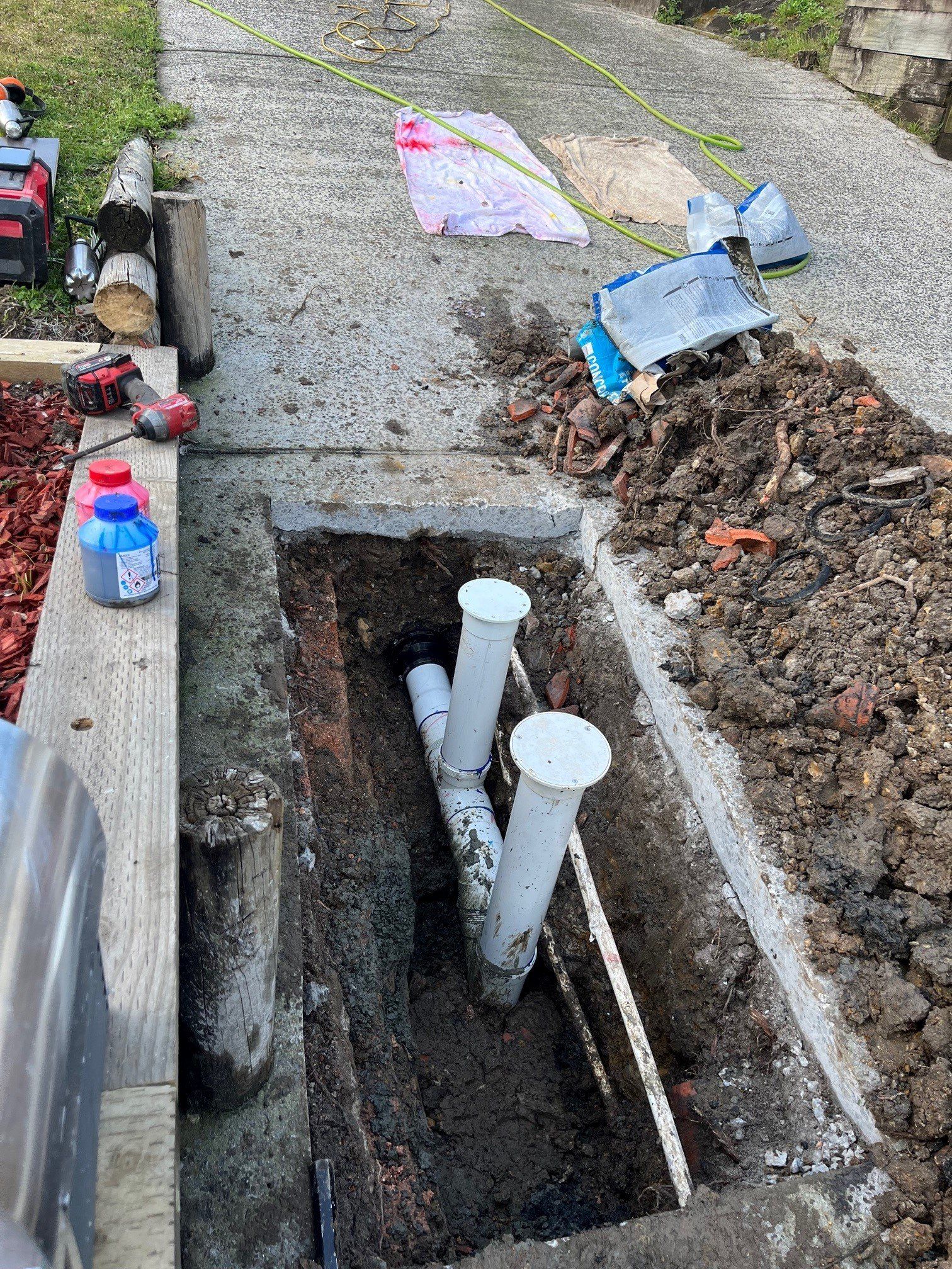 Plumber Wearing A Gloves And Holding A Wrench Repairing Pipe — Distinct Plumbing Services In Barrack Heights NSW