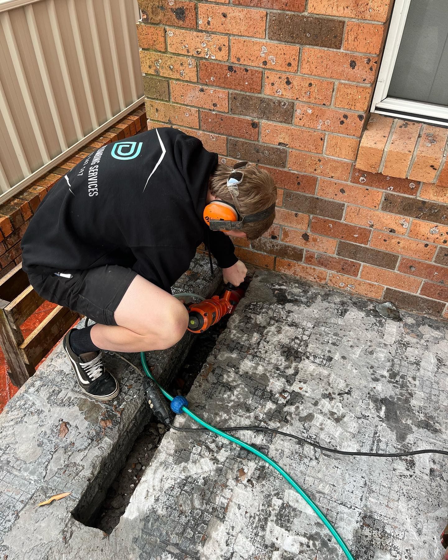 Male Plumber Checking Drainage Systems — Distinct Plumbing Services In Dapto, NSW