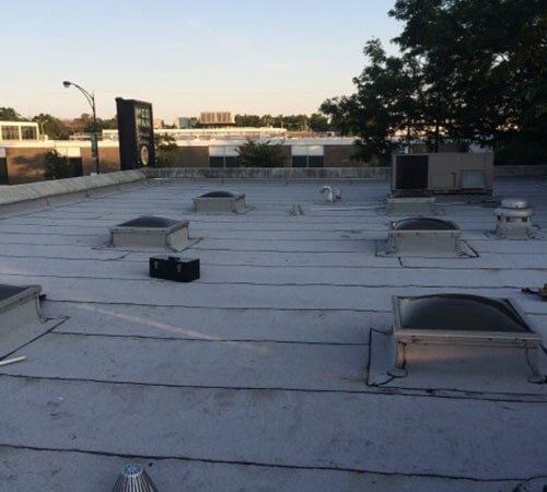 Roof Tarping — Business Flat Roof Before in Chicago, IL