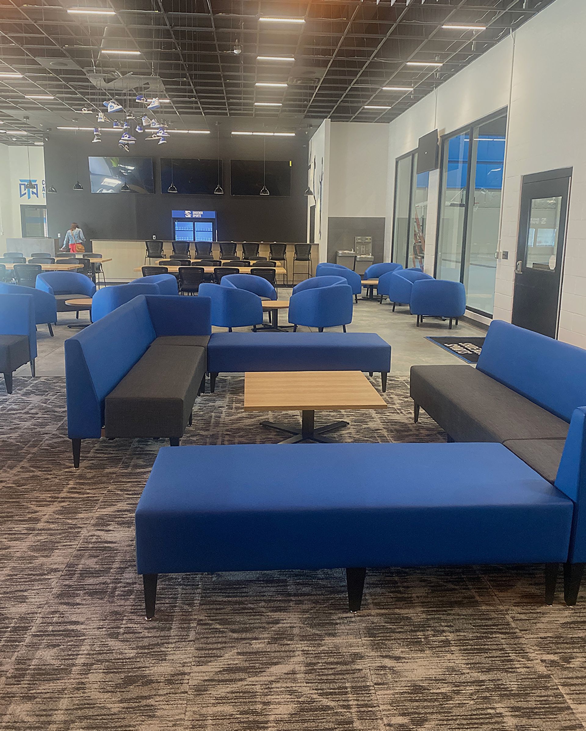 A large room with a lot of furniture and a lot of windows.