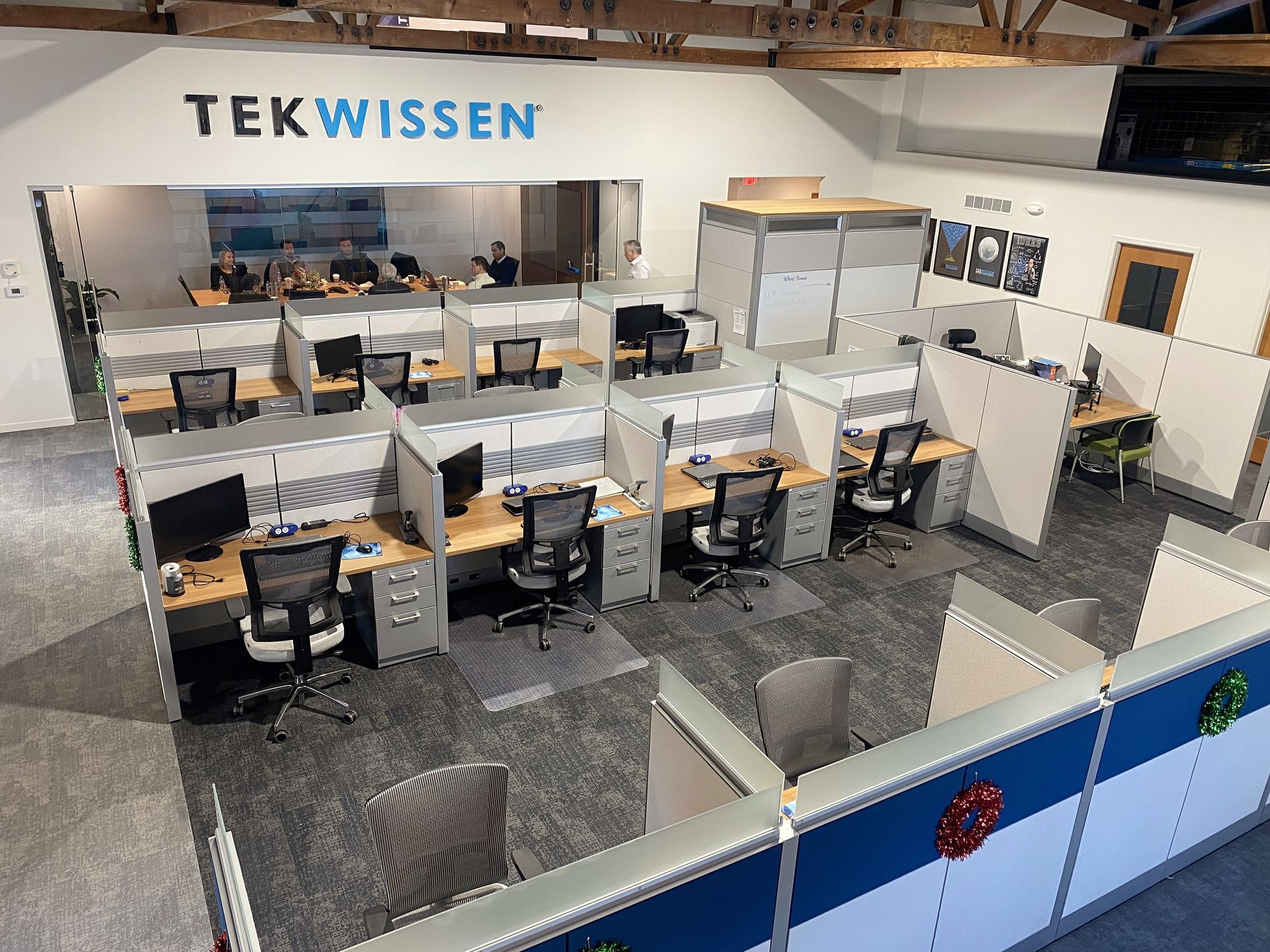 An aerial view of an office with cubicles and a sign that says tekwissen