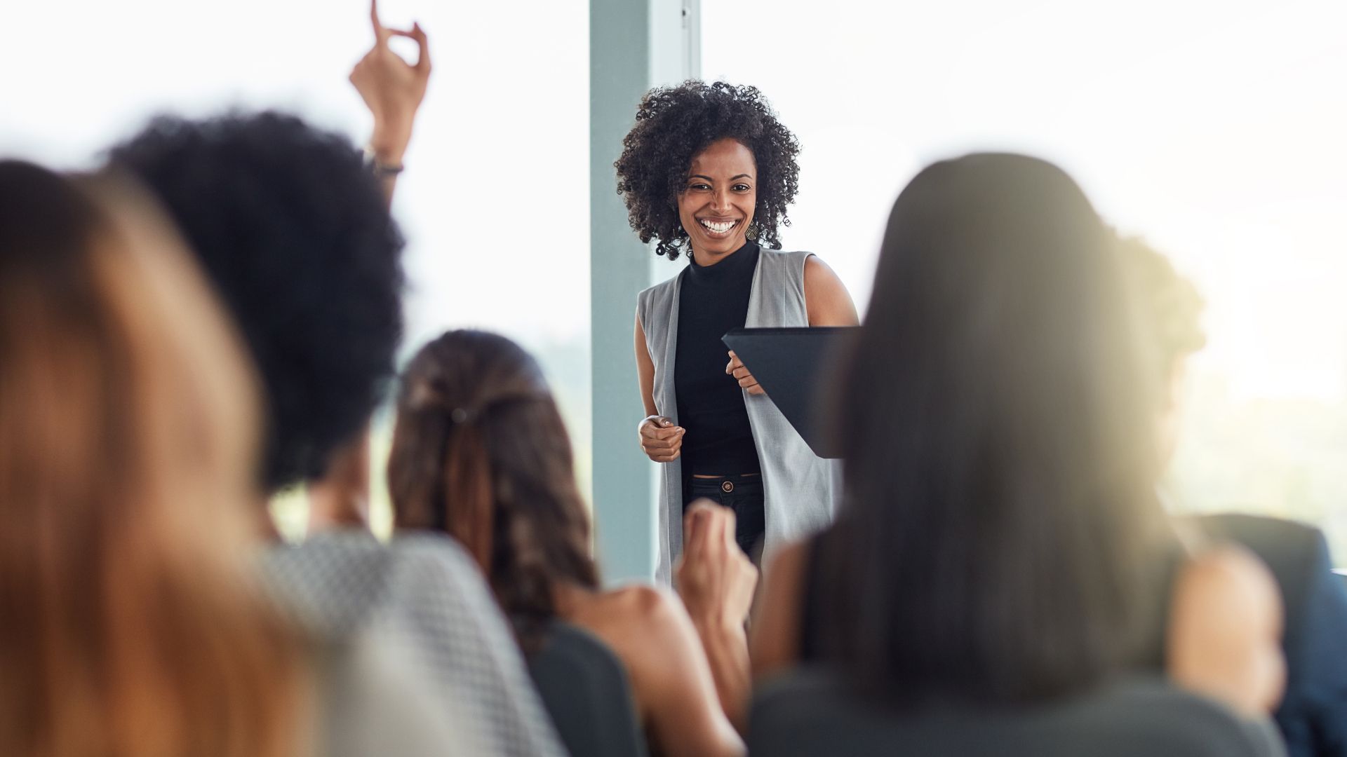 A woman is giving a presentation to a group of people.