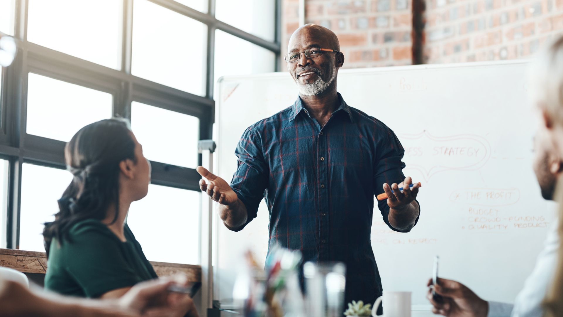 A man is giving a presentation to a group of people.