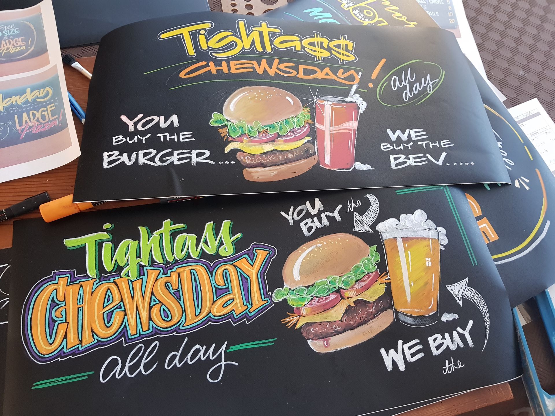 A chalkboard that says tightass chewsday all day