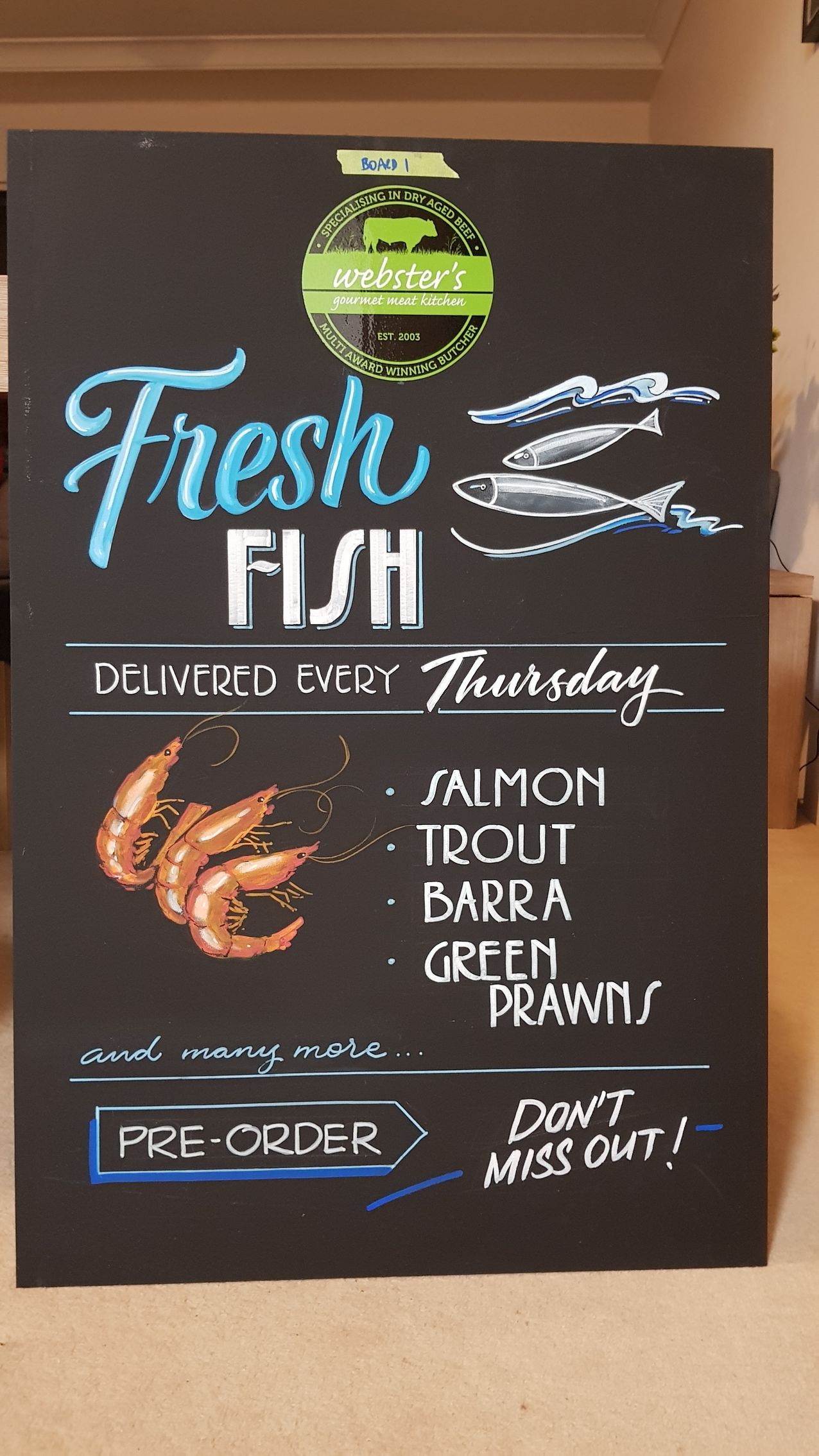 A chalkboard sign that says fresh fish on it