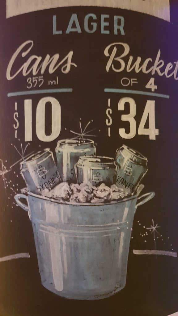 A sign that says lager cans bucket of 4 for $ 34