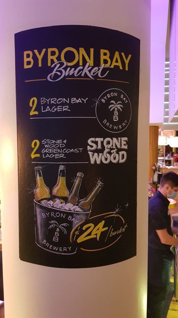 A sign on a wall that says byron bay bucket