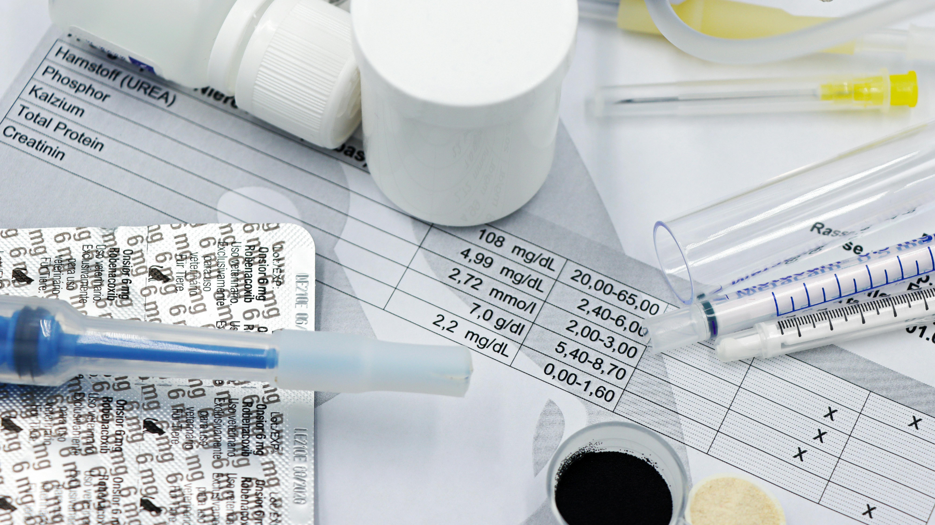 A syringe is sitting on top of a piece of paper