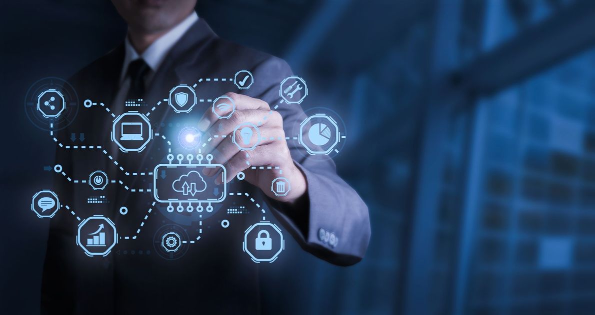 Businessman in a suit interacting with a glowing cloud computing network graphic. Blue tones.
