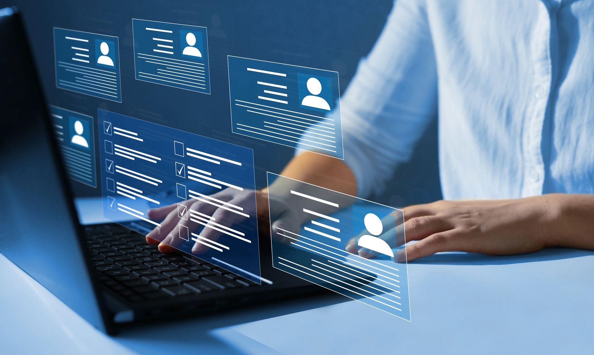 Person using laptop, reviewing candidate profiles on a screen, recruiting and hiring.
