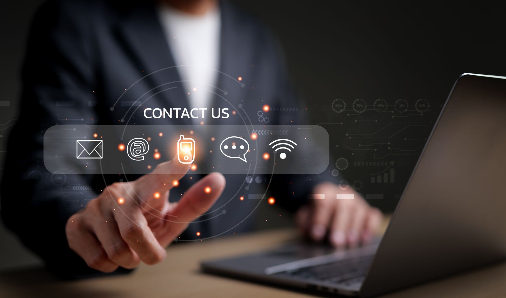 Person using a laptop, touching a glowing 