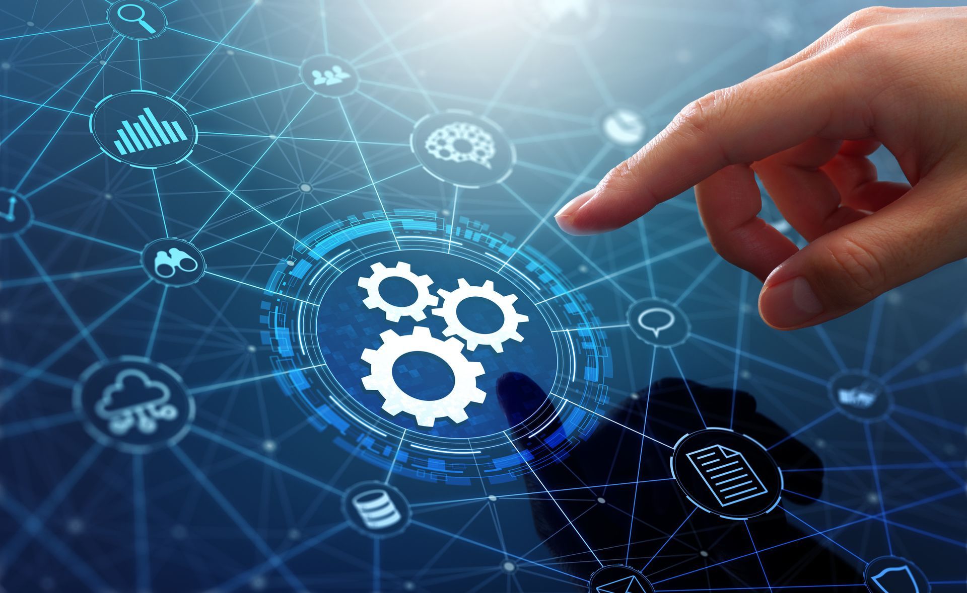 Hand touching digital gears and interconnected icons on a blue background, representing technology and automation.