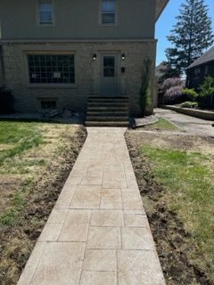 A stone walkway leading to the front door of a house.