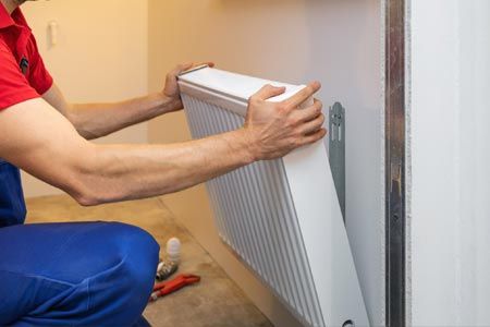 Heating — Man Installing Room Heater in Gaston, NC