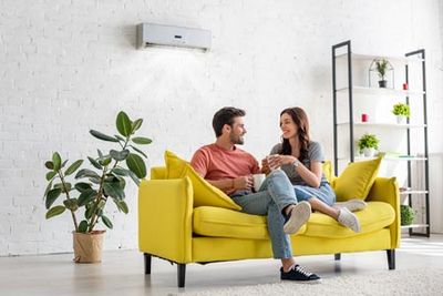 Air Conditioning Installation — Couple Talking in Living Room in Gaston, NC