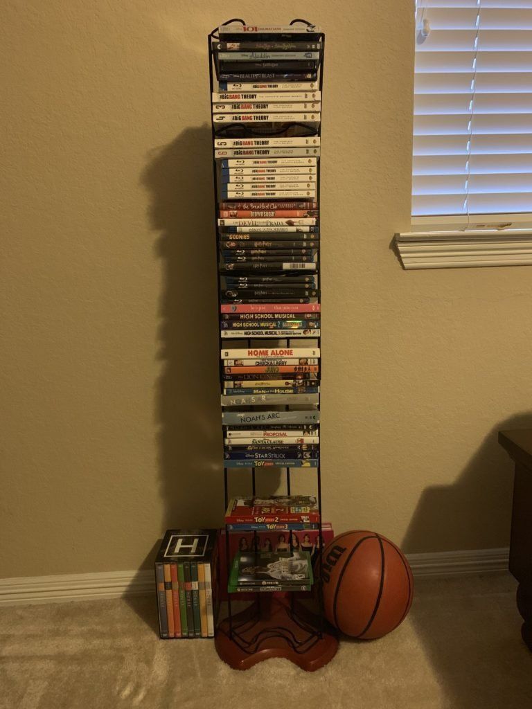 A collections of music and movie DVDs in a rack