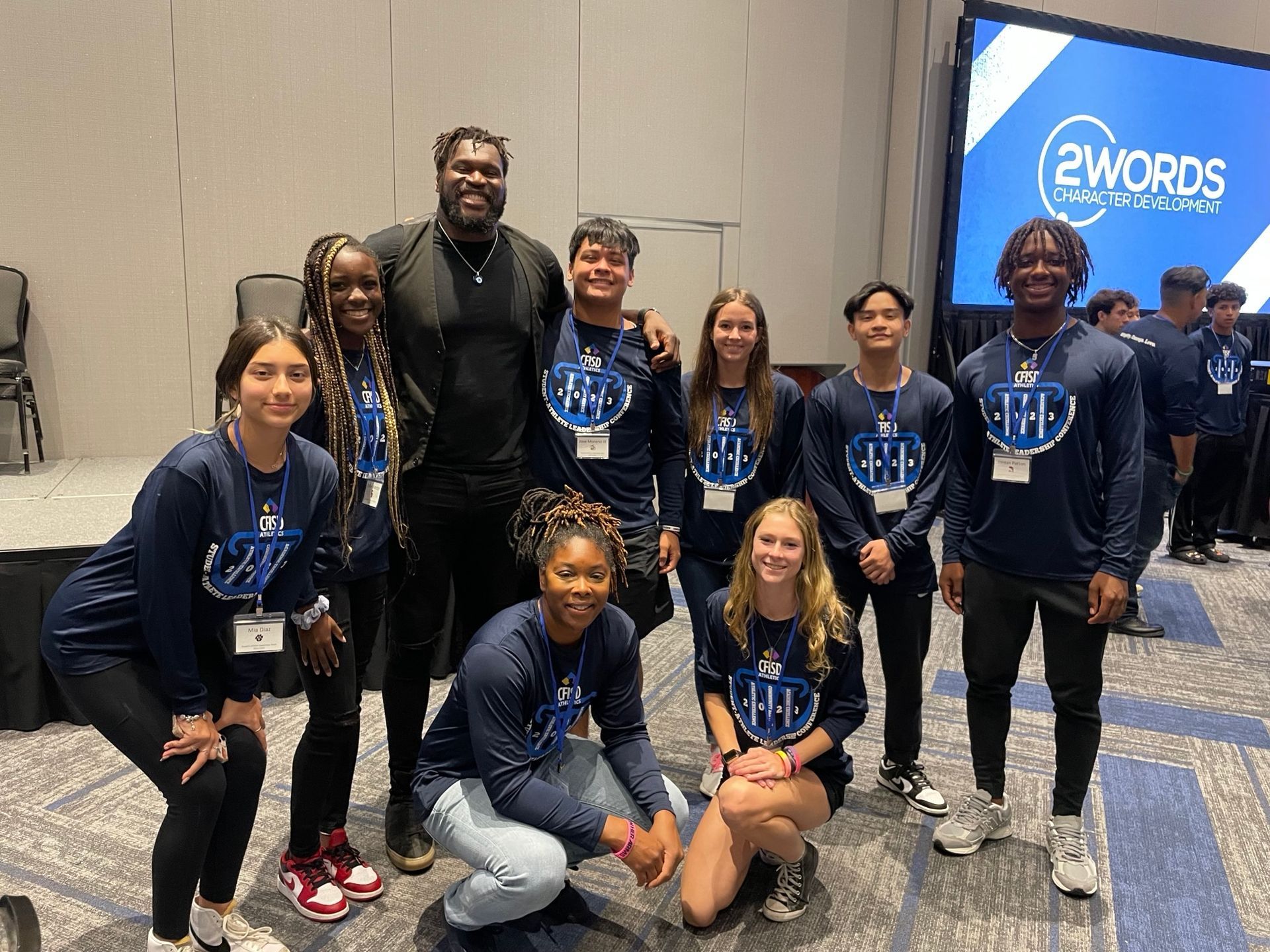 Two men talking while one of them writing something in clipboard