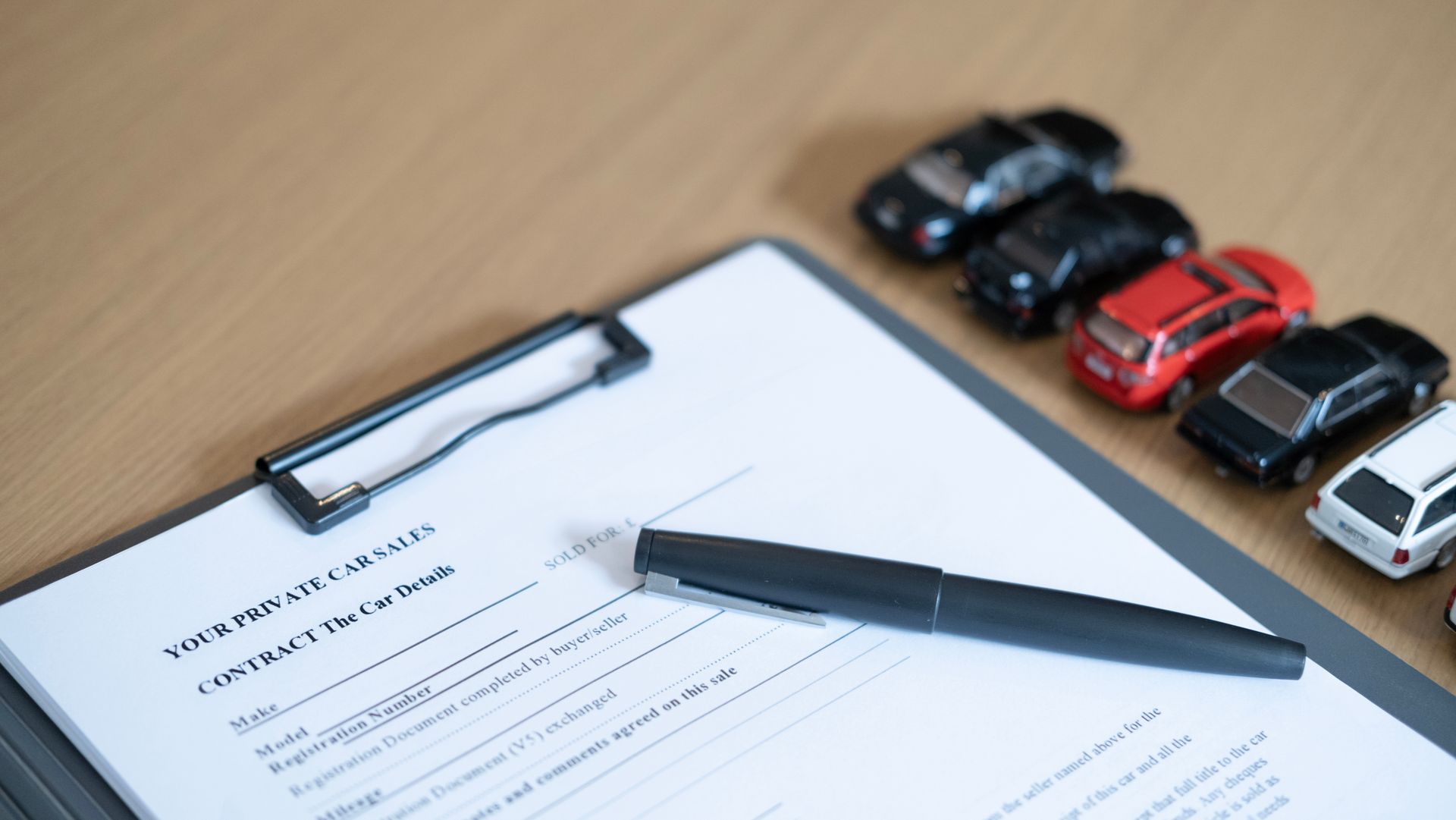 Auto insurance form with miniature cars.