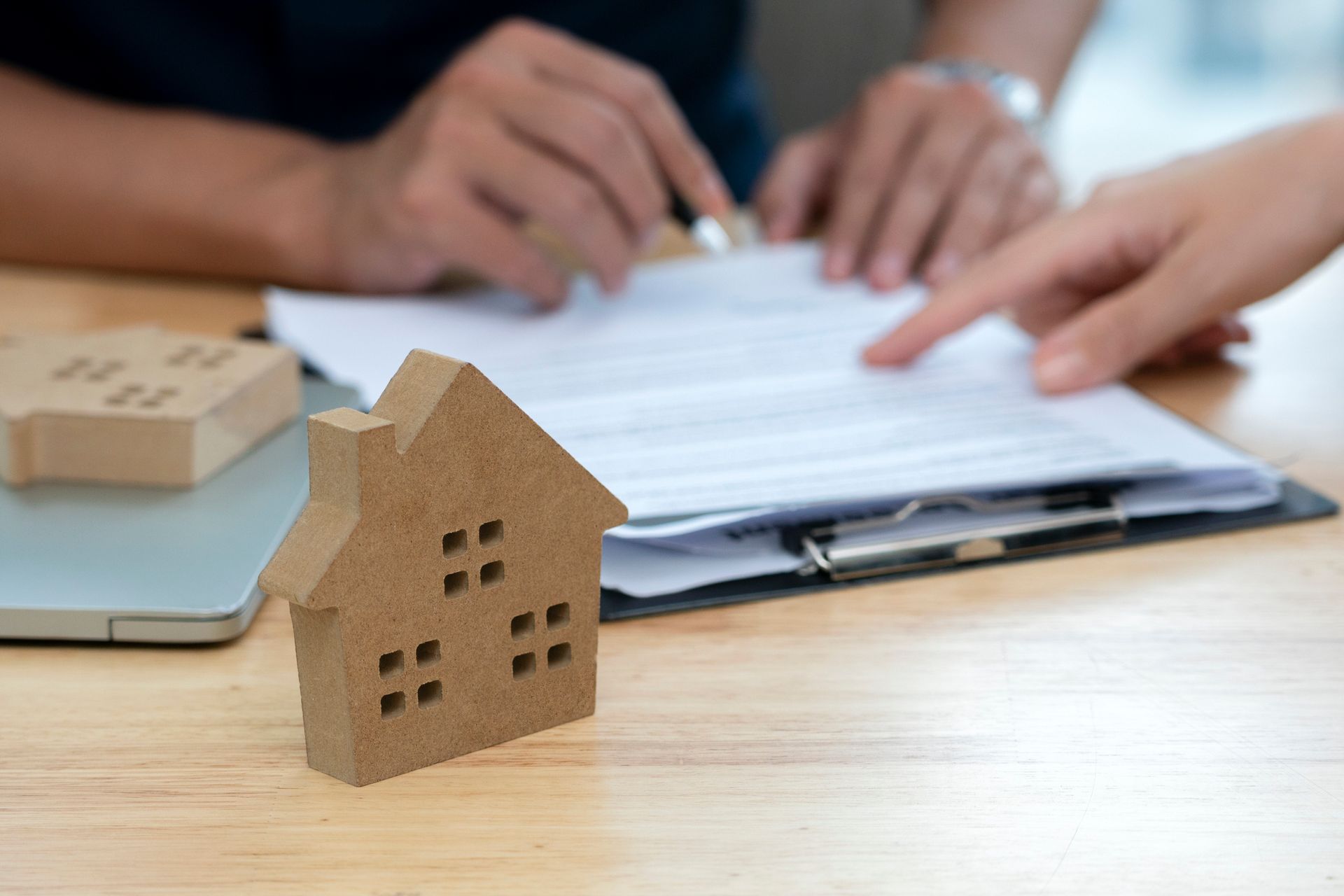 Insurance agent explaining home insurance policy coverage to a first-time homeowner.