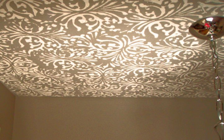 a ceiling with a pattern on it and a lamp hanging from it